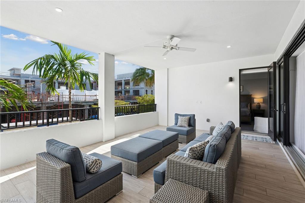 1135 3rd Avenue South, Unit 119 Naples, FL 34102 - Photo 38 of 50 a living room with furniture and a floor to ceiling window