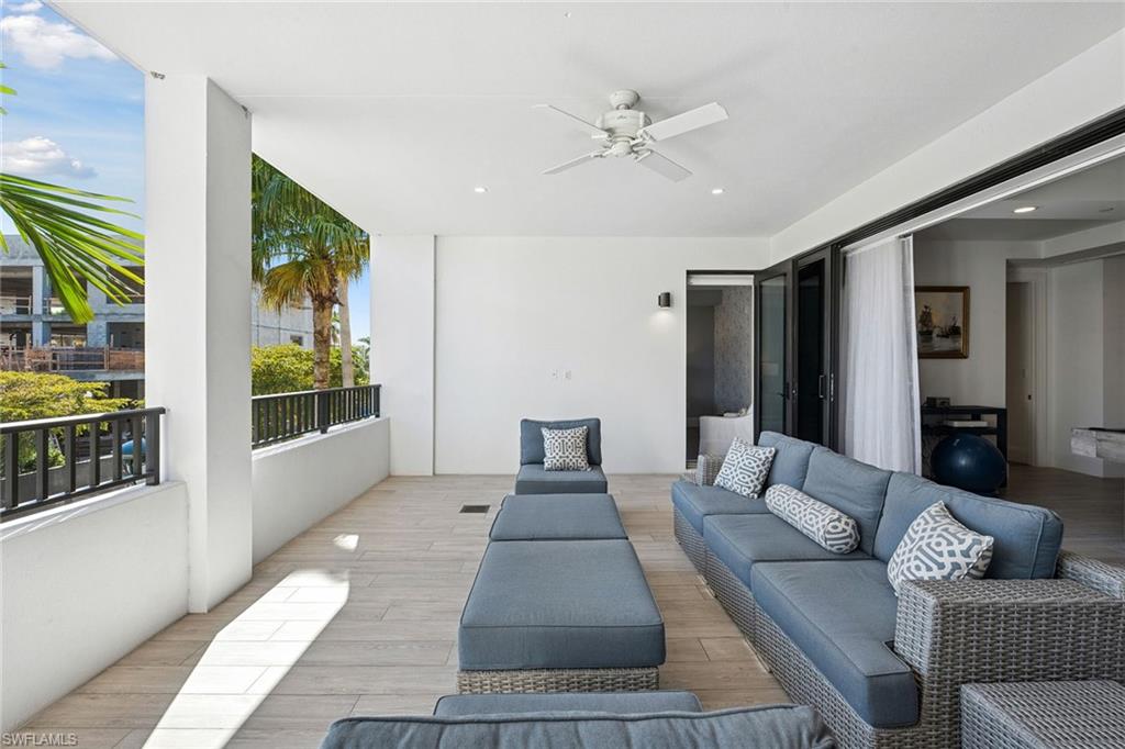 1135 3rd Avenue South, Unit 119 Naples, FL 34102 - Photo 39 of 50 a living room with furniture and a large window