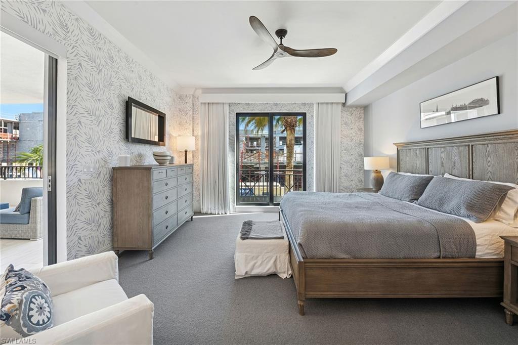 1135 3rd Avenue South, Unit 119 Naples, FL 34102 - Photo 40 of 50 a spacious bedroom with a bed and a couch