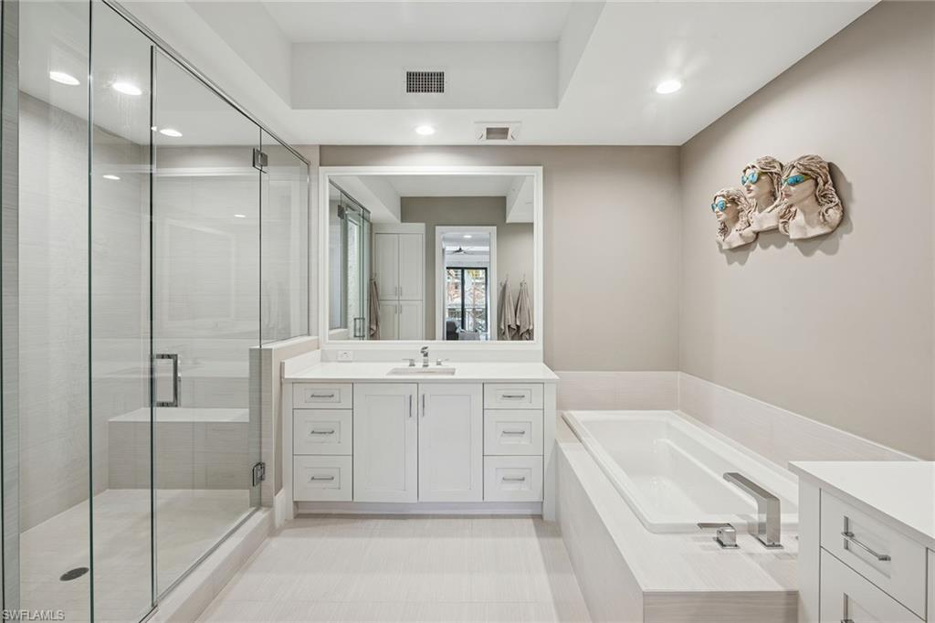 1135 3rd Avenue South, Unit 119 Naples, FL 34102 - Photo 42 of 50 a spacious bathroom with a tub sink and mirror