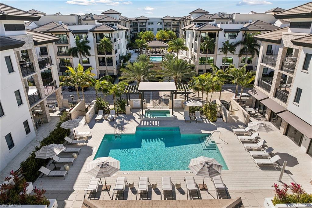 1135 3rd Avenue South, Unit 119 Naples, FL 34102 - Photo 49 of 50 a view of building with outdoor space and parking