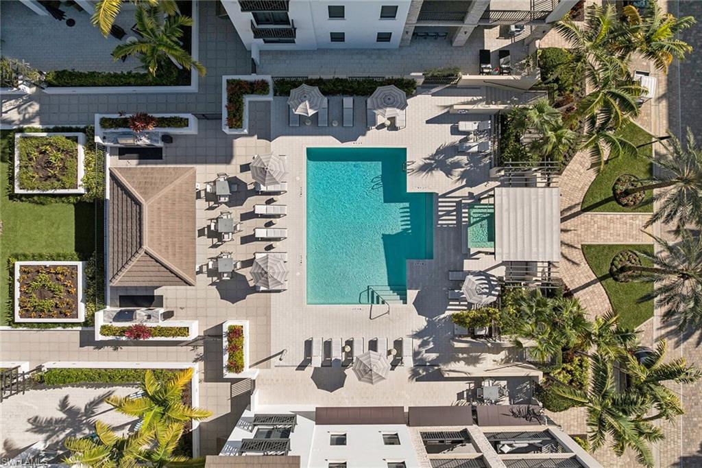 1135 3rd Avenue South, Unit 119 Naples, FL 34102 - Photo 50 of 50 a view of a patio with table and chairs with wooden floor