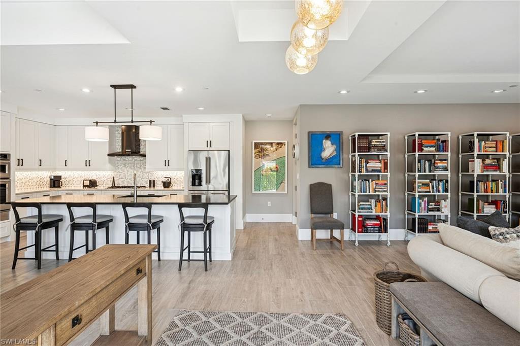 1135 3rd Avenue South, Unit 119 Naples, FL 34102 - Photo 5 of 50 a living room with stainless steel appliances kitchen island granite countertop furniture and a kitchen view