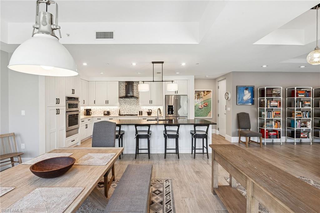 1135 3rd Avenue South, Unit 119 Naples, FL 34102 - Photo 7 of 50 a large kitchen with a table and chairs in it