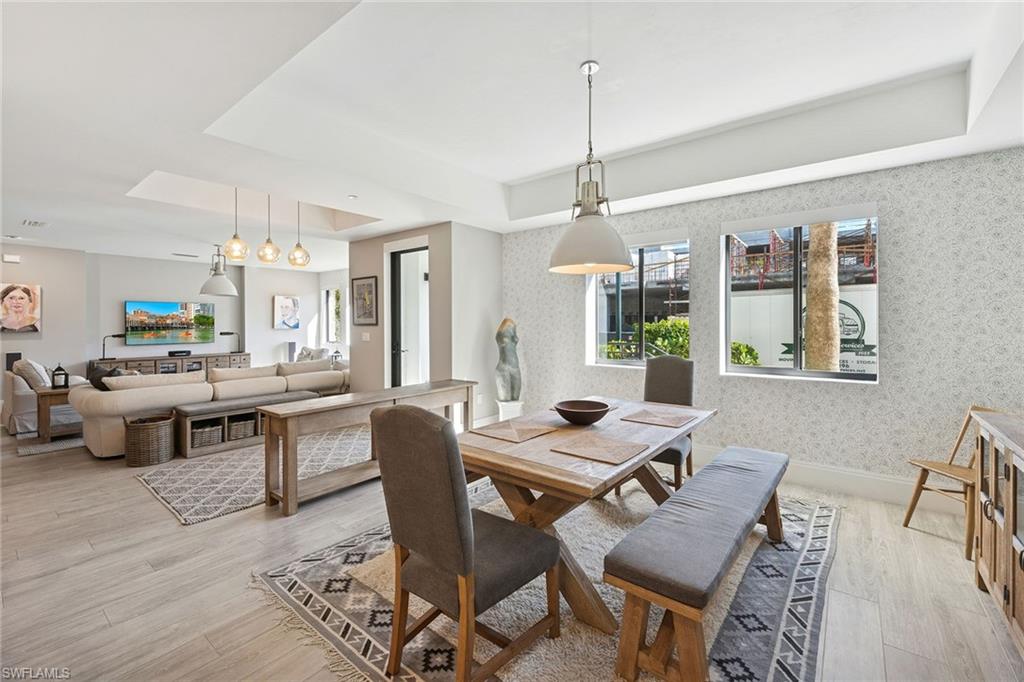 1135 3rd Avenue South, Unit 119 Naples, FL 34102 - Photo 10 of 50 a workspace with furniture a rug and wooden floor