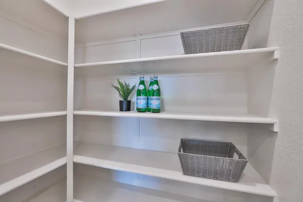 a dining area with a table chairs and a living room view