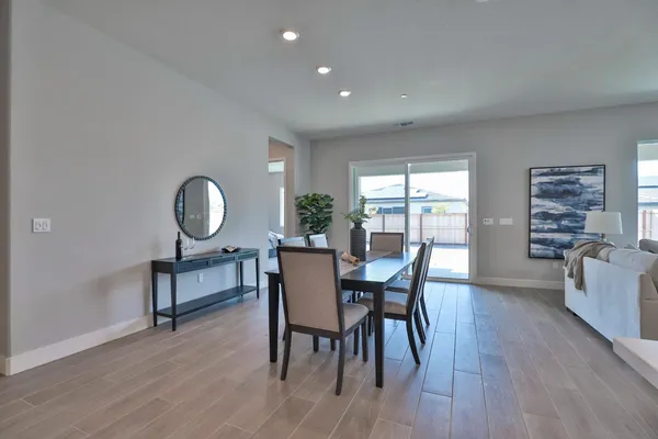 a bedroom with a bed a table and windows