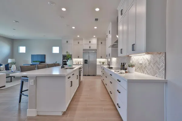 a kitchen with a sink cabinets and wooden floor