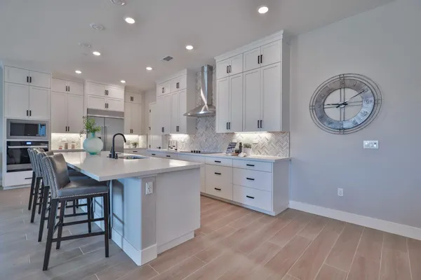 a kitchen with stainless steel appliances and cabinets