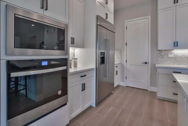 a kitchen with a table and chairs in it