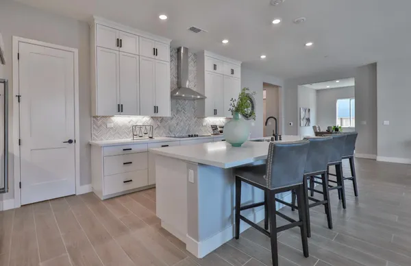 a kitchen with kitchen island a sink appliances and a counter top space