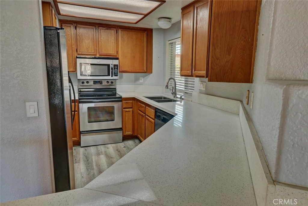 310 Lake Street Huntington Beach, CA 92648 - Photo 13 of 38 a kitchen with stainless steel appliances granite countertop a refrigerator sink and stove