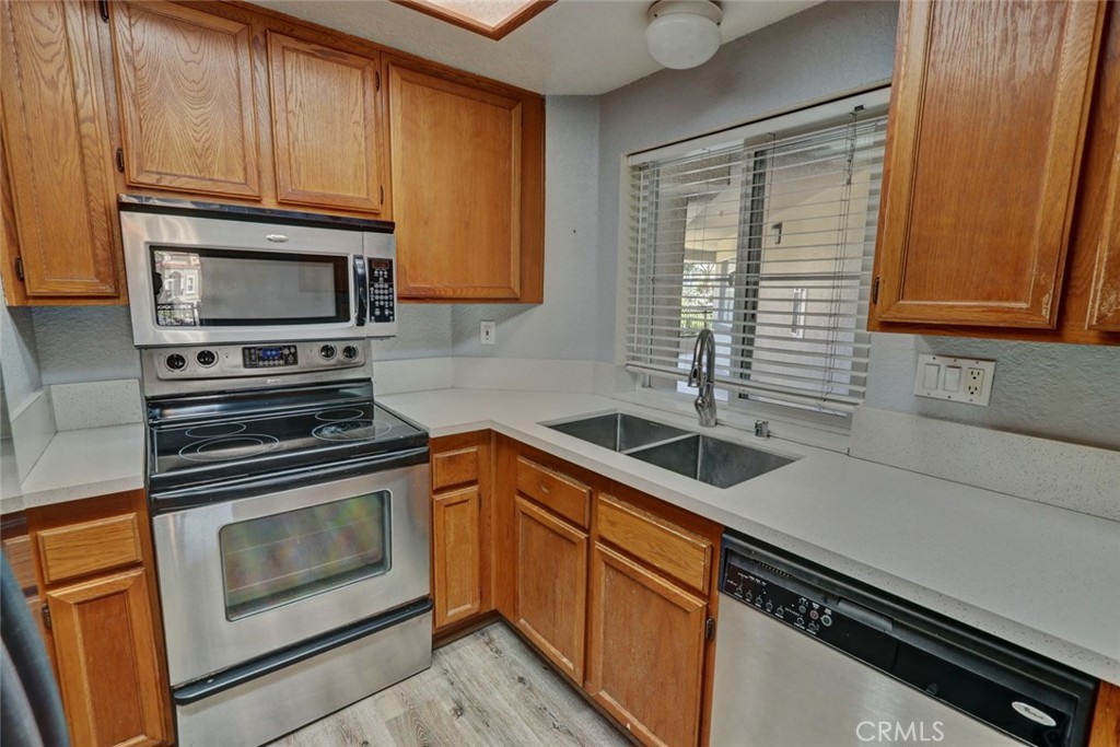 310 Lake Street Huntington Beach, CA 92648 - Photo 15 of 38 a kitchen with granite countertop a sink stainless steel appliances and cabinets