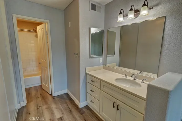 a bathroom with a shower and a bath tub