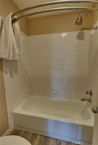 a room with a sink window and wooden floor