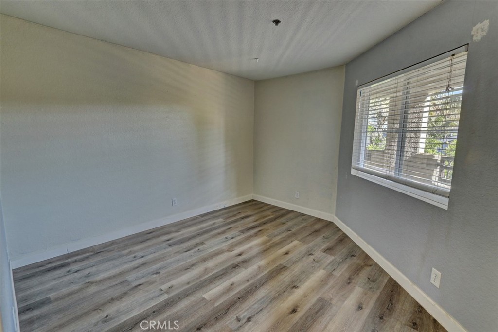 310 Lake Street Huntington Beach, CA 92648 - Photo 22 of 38 a view of empty room with wooden floor and fan