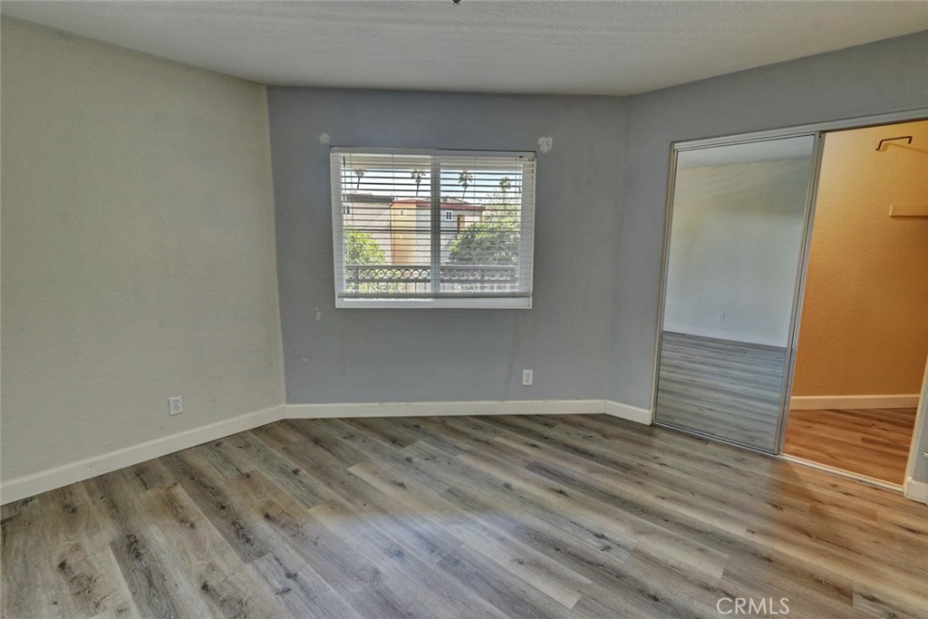 310 Lake Street Huntington Beach, CA 92648 - Photo 23 of 38 a view of an empty room with wooden floor and a window