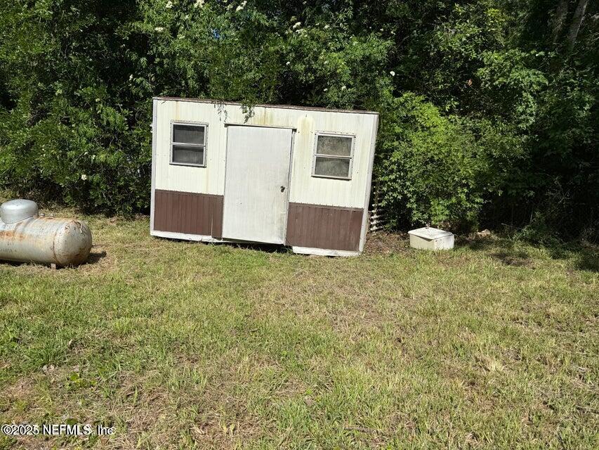 9324 Joos Road Jacksonville, FL 32220 - Photo 13 of 14 a view of a backyard with plants and large trees