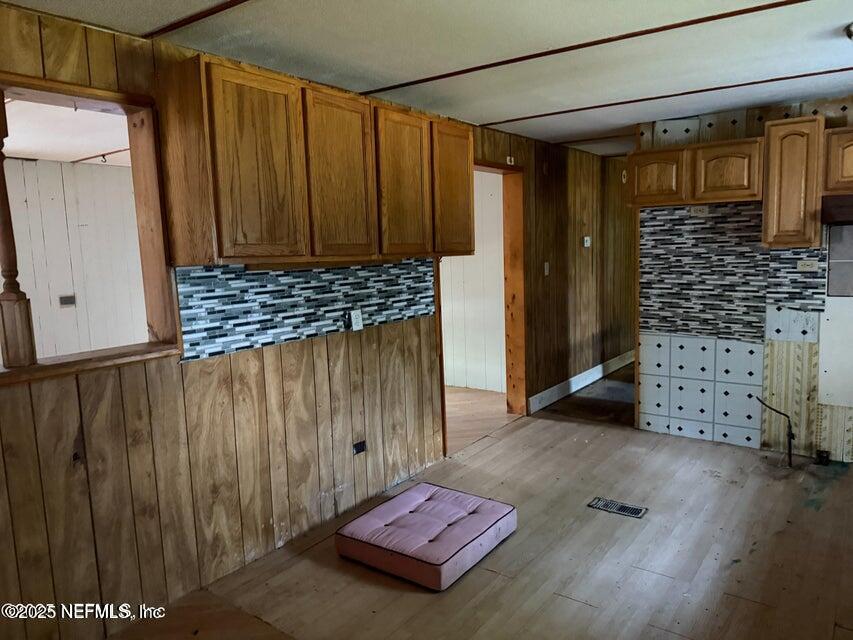 9324 Joos Road Jacksonville, FL 32220 - Photo 4 of 14 a view of a hallway with wooden floor and cabinet