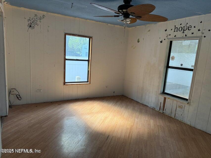 9324 Joos Road Jacksonville, FL 32220 - Photo 5 of 14 an empty room with a window and wooden floor