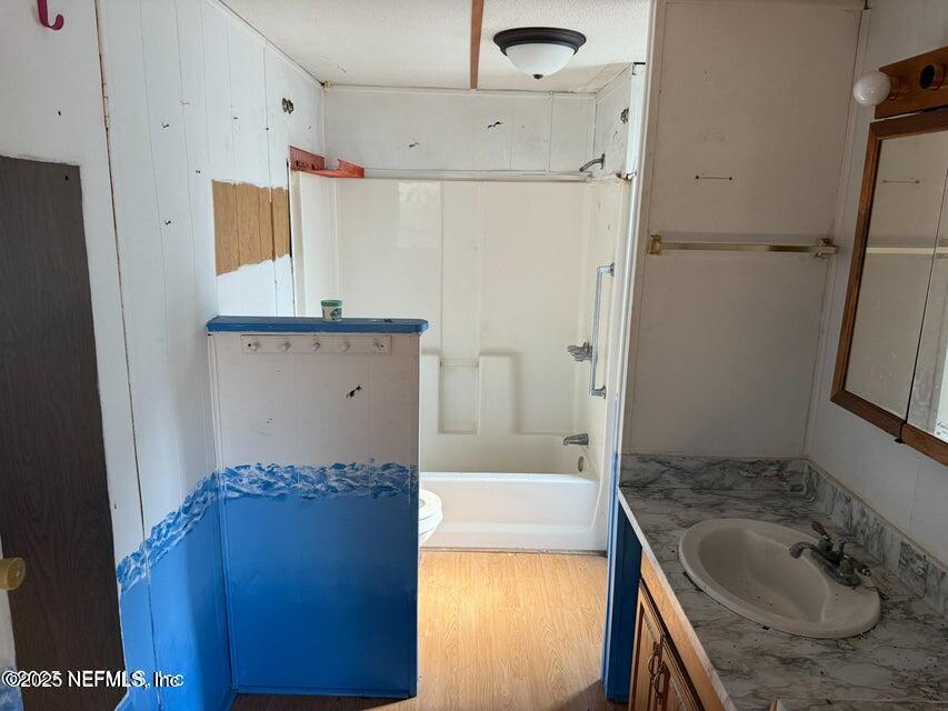 9324 Joos Road Jacksonville, FL 32220 - Photo 6 of 14 a bathroom with a granite countertop sink and washing machine