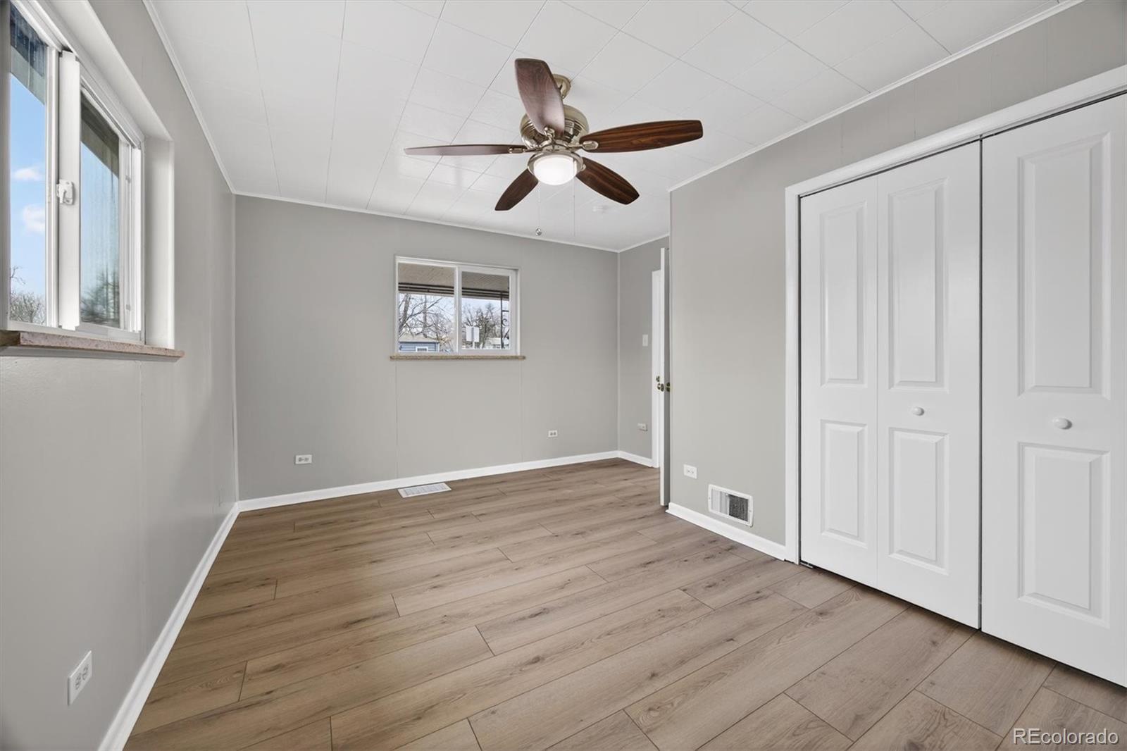705 Perry Street Denver, CO 80204 - Photo 14 of 23 a view of an empty room with wooden floor and a window