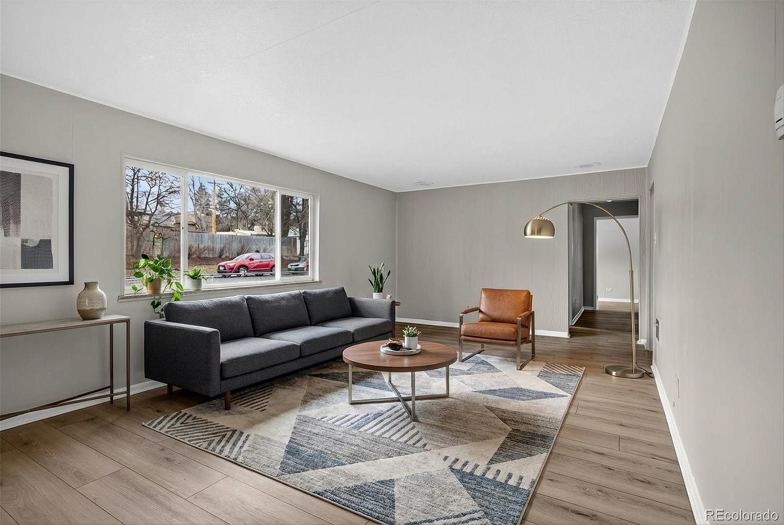 705 Perry Street Denver, CO 80204 - Photo 2 of 23 a living room with furniture and a large window