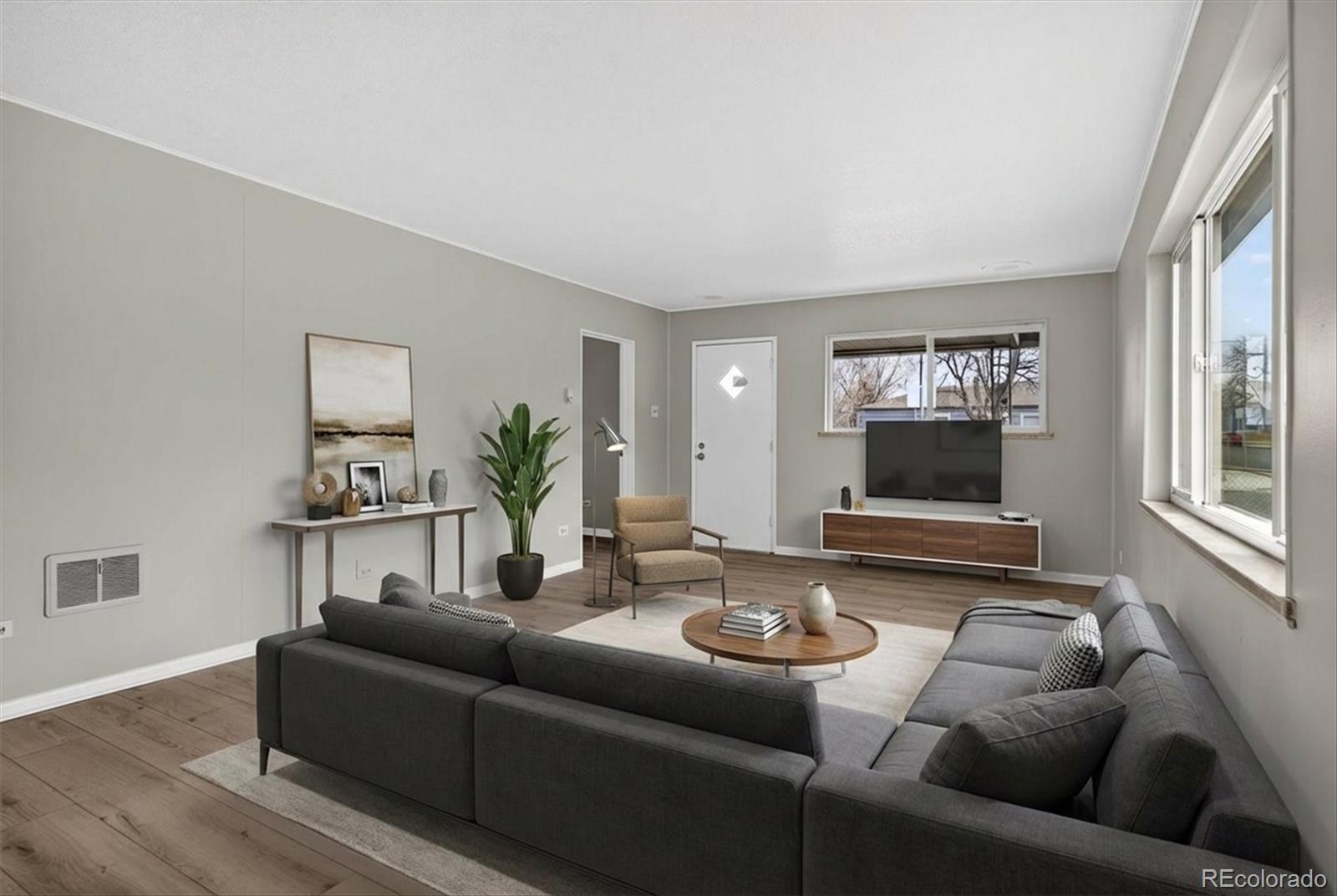 705 Perry Street Denver, CO 80204 - Photo 4 of 23 a living room with furniture and a flat screen tv