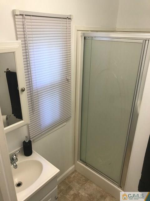 20 Burns Road, Unit 20 North Brunswick, NJ 08902 - Photo 13 of 18 a bathroom with a sink a mirror and shower