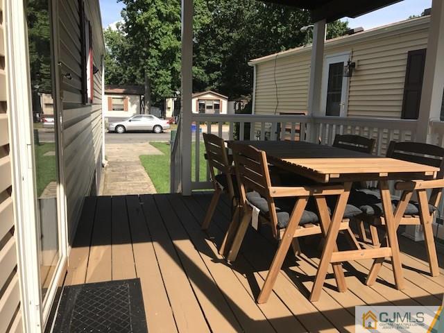 20 Burns Road, Unit 20 North Brunswick, NJ 08902 - Photo 15 of 18 a balcony view with a dining table and chairs with wooden floor