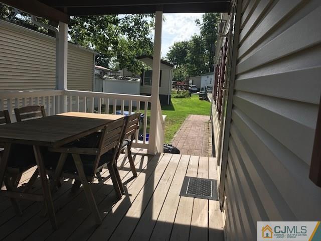 20 Burns Road, Unit 20 North Brunswick, NJ 08902 - Photo 16 of 18 a view of backyard with a deck and hardwood floor