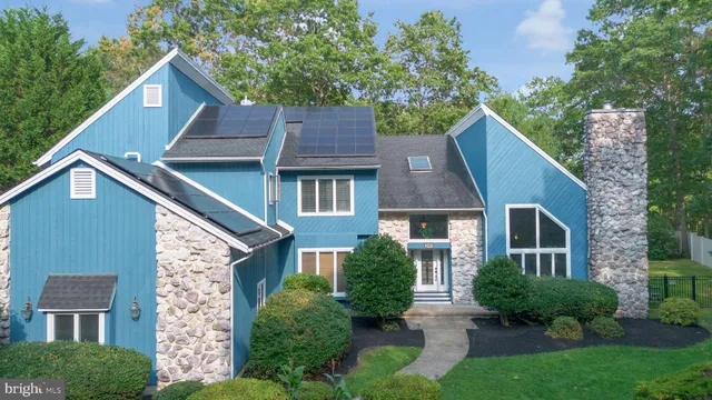 a aerial view of a house next to a yard