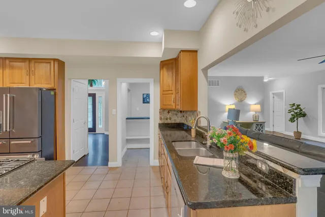 a bathroom with a granite countertop sink a mirror and vanity