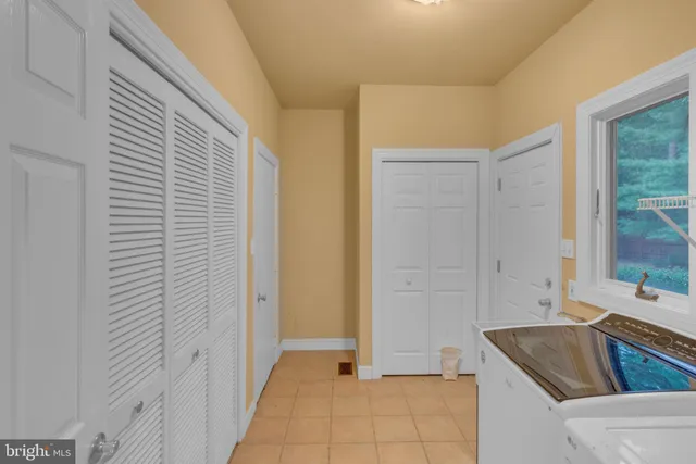 an aerial view of a house swimming pool and tennis court