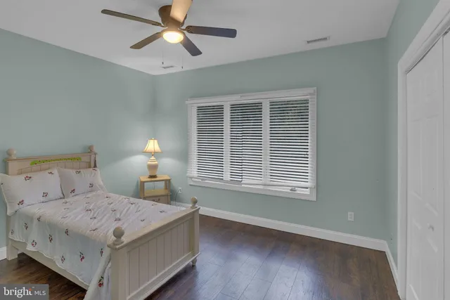 a view of a house with a tree and sitting area