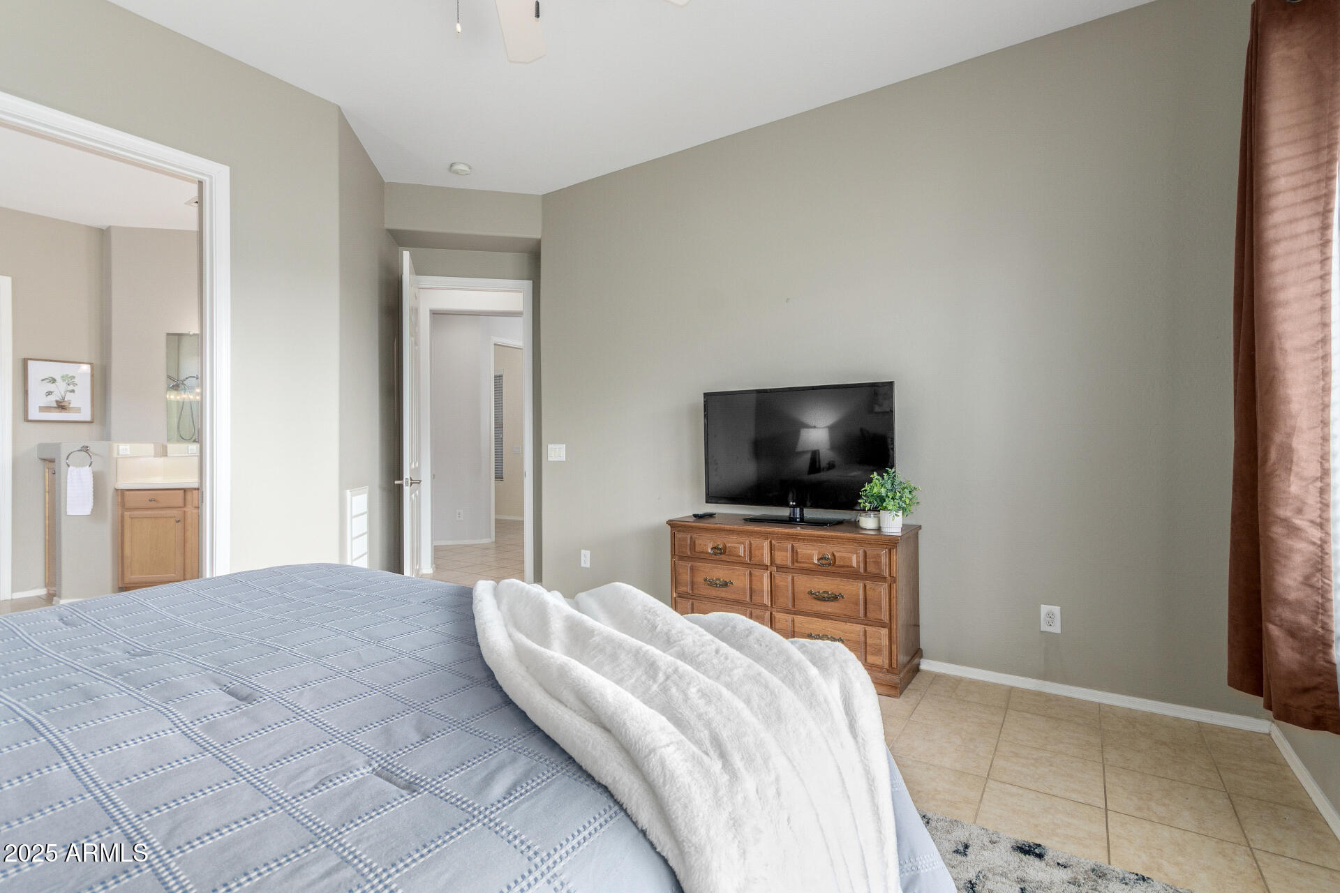 4553 East Narrowleaf Drive Gilbert, AZ 85298 - Photo 15 of 60 a bedroom with a bed and a flat screen tv