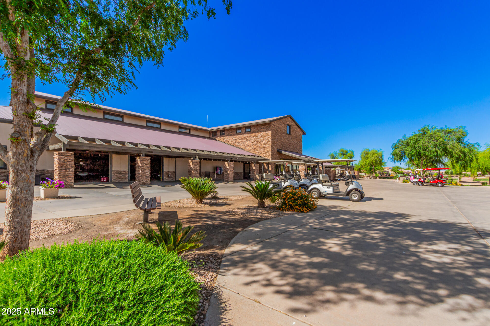 4553 East Narrowleaf Drive Gilbert, AZ 85298 - Photo 46 of 60 a view of a patio with table and chairs under an umbrella with palm trees