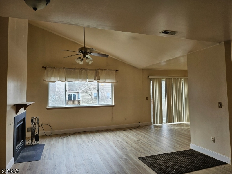 78 Falcon Ridge Way North, Unit 8 Hamburg, NJ 07419 - Photo 8 of 14 a view of a room with wooden floor and a ceiling fan