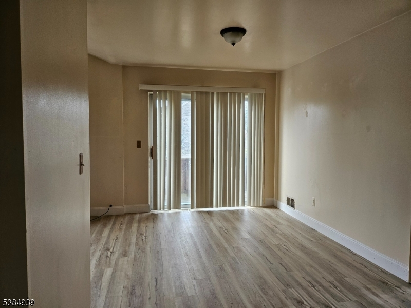 78 Falcon Ridge Way North, Unit 8 Hamburg, NJ 07419 - Photo 9 of 14 an empty room with wooden floor and windows