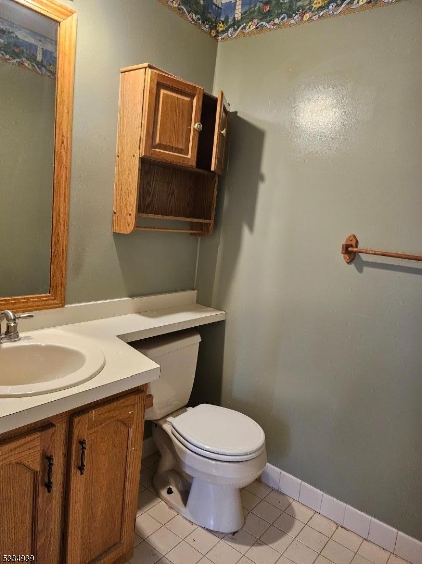 78 Falcon Ridge Way North, Unit 8 Hamburg, NJ 07419 - Photo 10 of 14 a bathroom with a toilet a sink and mirror