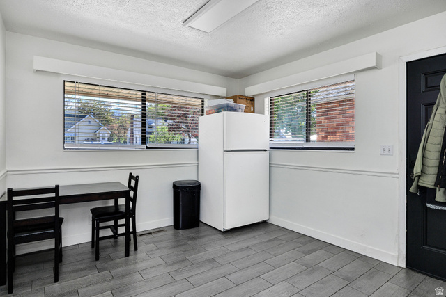 667 North 100 East Logan, UT 84321 - Photo 19 of 41 Dining area featuring wood finish floors and a textured ceiling