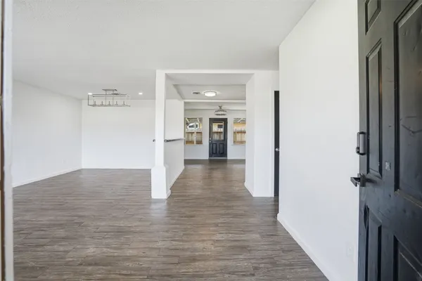 a view of a hallway with wooden floor