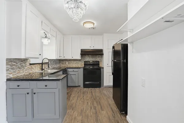 a kitchen with a sink and a refrigerator