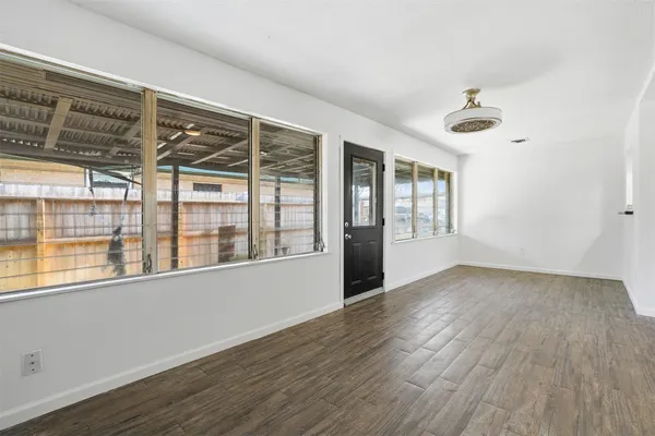 wooden floor in an empty room with a window