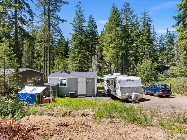 an aerial view of a house with a garden and parking space