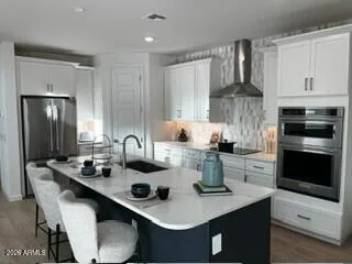 a kitchen with appliances a sink and cabinets