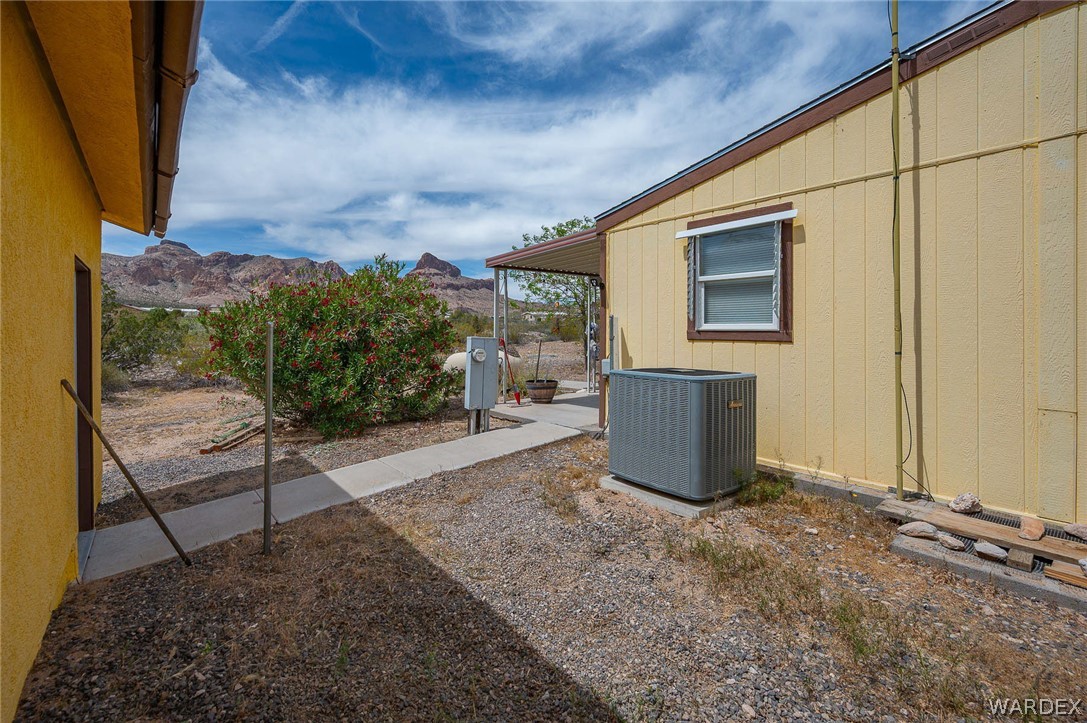 2465 Egar Road Golden Valley, AZ 86413 - Photo 43 of 98 The property features a yellow exterior and a window with a white frame