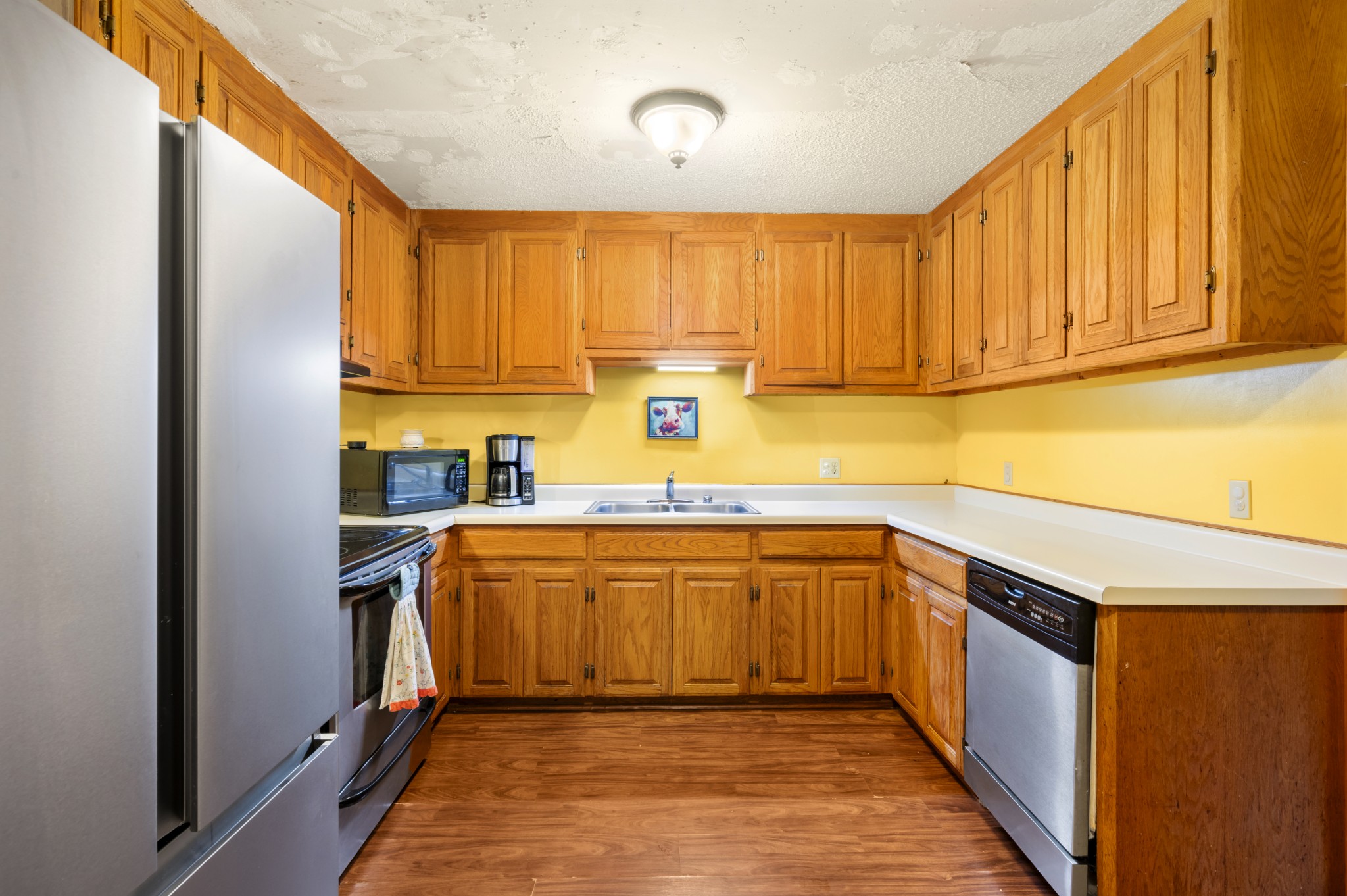 105 Flower Lane Paris, TN 38242 - Photo 13 of 25 a kitchen with stainless steel appliances granite countertop a refrigerator and a sink