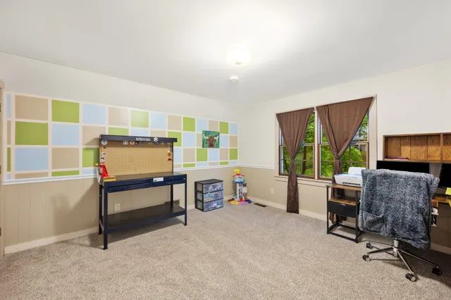 a view of a livingroom with furniture and a window