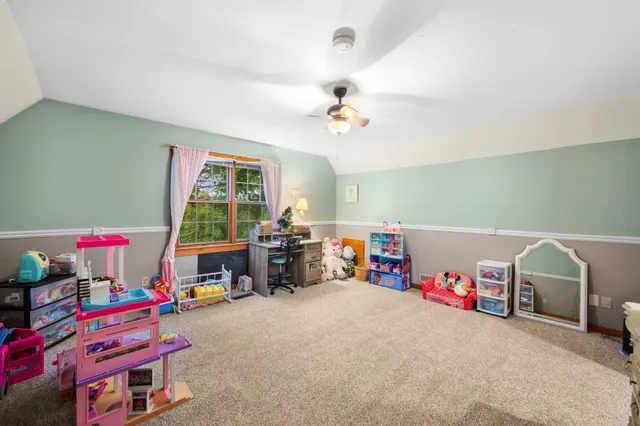 a playing room with toys and a baby crib